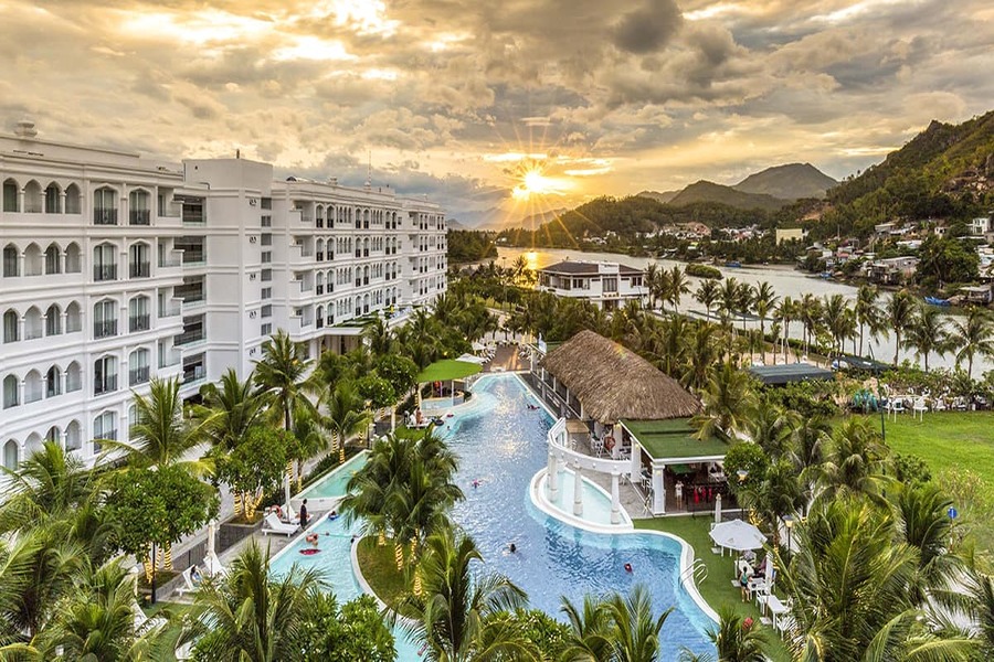 Piscine du Champa Island Resort à Nha Trang entourée de nature tropicale et d’architecture vietnamienne