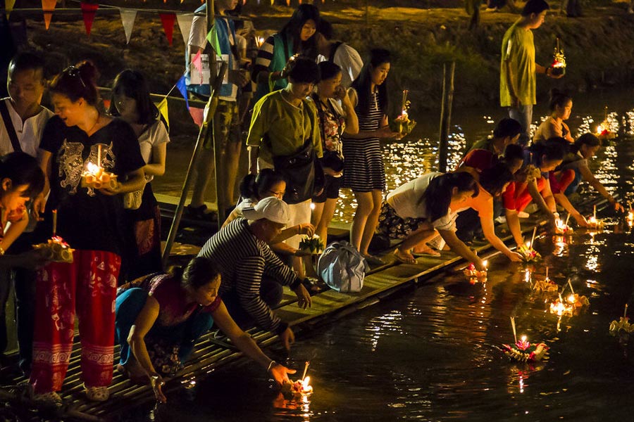 Les habitants lâchent des lanternes sur la rivière de Hoai dans le festival des lanternes à Hoi An 